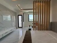 Studio Condo for Sale at Thepthip Mansion Condominium open layout showing bed, marble TV wall, and living space with window view