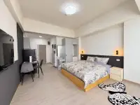 Studio Condo for Rent at Thian Tong Condotel open-plan bedroom with wooden bed, wardrobe, and workspace