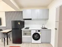 Studio Condo for Rent at Thian Tong Condotel kitchen counter with sink, stove top, washing machine, and storage cabinets