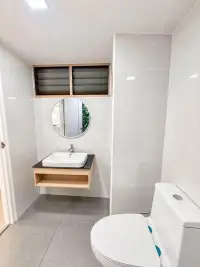 Studio Condo for Rent at Thian Tong Condotel modern bathroom with floating wood vanity and round mirror