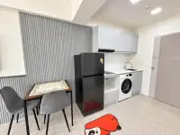 Studio Condo for Rent at Thian Tong Condotel compact kitchenette with black fridge, washing machine, and dining table
