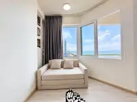 Studio Condo for Rent at Thian Tong Condotel beige sofa nook with panoramic sea and city view windows