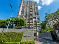 2 Bedroom Condo for Sale at Baan Plai Haad high-rise tower exterior with entrance signage and landscaping