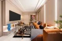 4 Bedroom House for Sale at Chieftain entertainment lounge with large TV, amber velvet sofa, brass bar cart, and pop-art wall decor