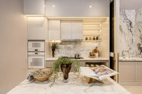 4 Bedroom House for Sale at Cascade modern kitchen with marble island countertop, built-in ovens, marble backsplash, and under-cabinet LED lighting