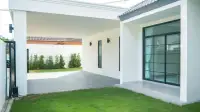 4 Bedroom House for Sale in Jomtien covered carport and front entrance with glass sliding door