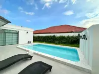 4 Bedroom House for Sale in Jomtien private pool with marble deck and sun loungers at dusk