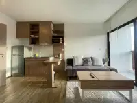 1 Bedroom Condo for Sale at Treetops Condo kitchen with fridge, microwave, and lounge area near balcony