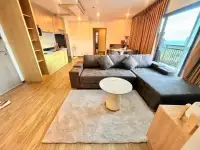 2 Bedroom Condo for Sale at Treetops Condo living area with sea view balcony and plush area rug