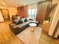 2 Bedroom Condo for Sale at Treetops Condo spacious lounge with sectional sofa and dining nook by window