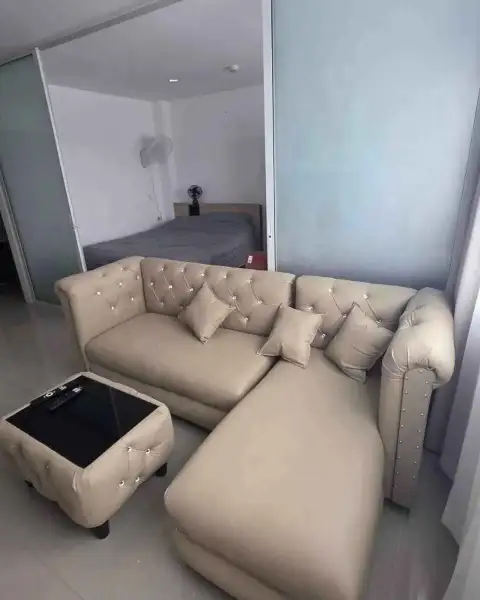 2 Bedroom Condo for Rent at Trio Gems living area sofa with view into bedroom through glass partition