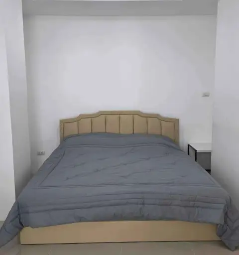2 Bedroom Condo for Rent at Trio Gems bedroom with upholstered headboard and grey bedding