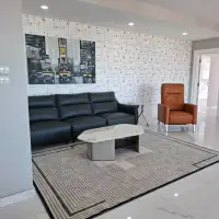 3 Bedroom Condo for Sale at Tropicana Pratumnak living room with black leather sofa and orange armchair