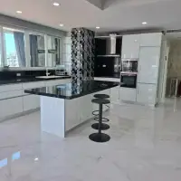 3 Bedroom Condo for Sale at Tropicana Pratumnak modern kitchen with white cabinetry and black countertop island