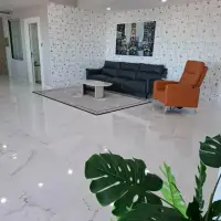 3 Bedroom Condo for Sale at Tropicana Pratumnak spacious living area with marble flooring and patterned accent wall