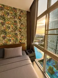 1 Bedroom Condo for Sale at The Twin Tower Jomtien Beach Pattaya bedroom with jungle print wall and pool sunset view