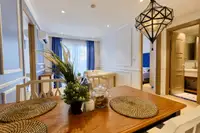 2 Bedroom Condo for Sale at Seven Seas Cote d'Azur: close-up of dining table with decor, looking towards living room and bathroom.