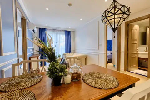 2 Bedroom Condo for Sale at Seven Seas Cote d'Azur: close-up of dining table with decor, looking towards living room and bathroom.