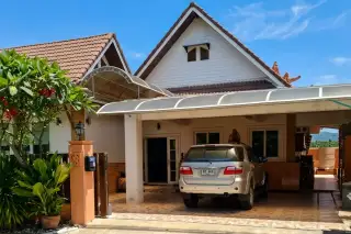 Hansa Paradise Hill house exterior with tiled roof, covered carport and SUV parked in driveway