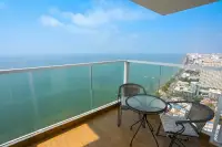 3 Bedroom Condo for Sale at Cetus Beachfront high-floor balcony with rattan chairs and panoramic sea and Pattaya city view