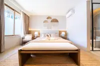 4 Bedroom House for Sale at The Sunshine House boho master bedroom with king bed, macrame wall art and en-suite bathroom