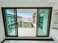 2 Bedroom Condo for Sale at The Urban Pattaya living room sliding glass doors opening to balcony and courtyard view