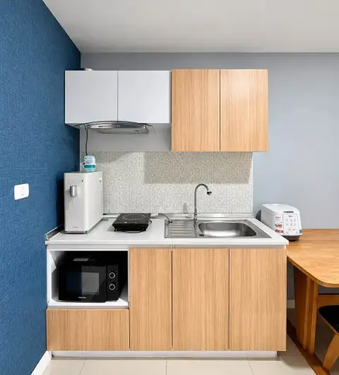 2 Bedroom Condo for Rent at Unicca kitchenette with wooden cabinets, sink, stove, and microwave
