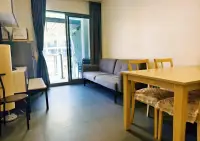 1 Bedroom Condo for Rent at Unixx South Pattaya living and dining area with gray sofa and wooden dining table