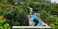 1 Bedroom Condo for Rent at Unixx South Pattaya aerial view of resort pool with waterslide and lush gardens