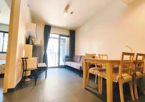 1 Bedroom Condo for Rent at Unixx South Pattaya dining table and lounge seating with balcony doors