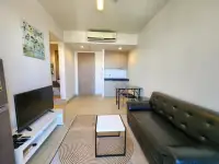 1 Bedroom Condo for Sale & Rent at Unixx South Pattaya open-plan living room with kitchenette and TV unit