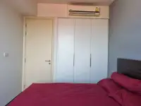 1 Bedroom Condo for Rent at Unixx South Pattaya bedroom with white wardrobe and red bedding