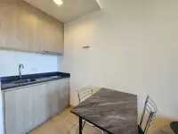 1 Bedroom Condo for Sale & Rent at Unixx South Pattaya kitchenette with dark countertop and dining table
