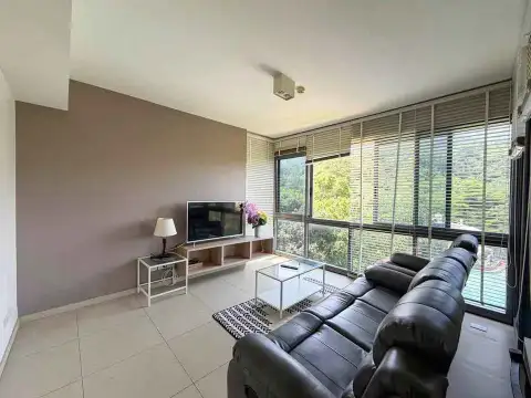 2 Bedroom Condo for Rent at Unixx South Pattaya open living room with black leather sofa and scenic window views