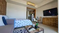 Studio Condo for Rent at Unixx South Pattaya open layout with bed, sofa, TV, and kitchenette entrance