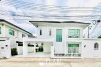 3 Bedroom House for Sale at Baan Pruksa Nara Chaiyapruek: modern white exterior with car park and fence under cloudy sky.