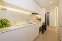 Studio Condo for Sale at Sands Condominium modern kitchen with marble countertop white cabinets LED lighting and washer