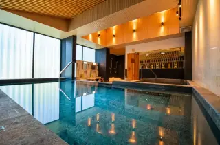 Dormy Residences Sriracha indoor reflective pool with wooden ceiling and ambient lighting