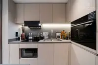 2 Bedroom Condo for Sale at Panora Estuaria close-up of a modern kitchen with built-in microwave and oven.