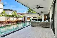 4 Bedroom House for Sale & Rent in Bang Lamung covered poolside terrace with rattan sofa and ceiling fans overlooking private pool