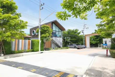 Supalai Ville Pattaya - Motorway clubhouse exterior with large glass windows and speed bump at entrance