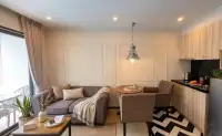 1 Bedroom Condo for Rent at Venetian Signature Condo Resort living area with sofa and open kitchenette
