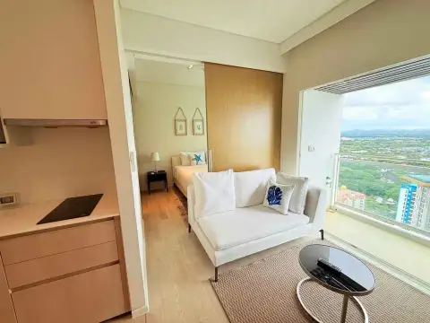 1 Bedroom Condo for Rent at Veranda Residence Pattaya open-plan kitchenette with sofa, bedroom and balcony view