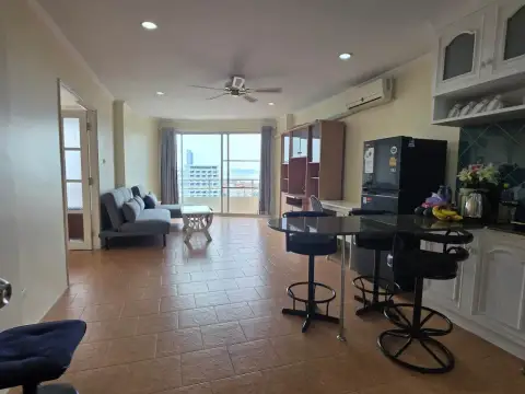1 Bedroom Condo for Rent at View Talay 1 living and dining area with bar stools and sea view balcony