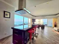 2 Bedroom Condo for Sale at View Talay 3A 2 Bedroom Condo for Sea at View Talay 3A kitchen counter with red stools and balcony sea view