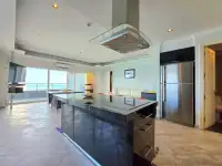 2 Bedroom Condo for Sale at View Talay 3A kitchen island with stainless fridge and ocean-view balcony