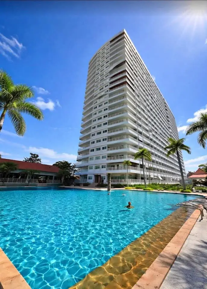 1 Bedroom Condo for Sale at View Talay 5D high-rise tower exterior with large pool and palm trees