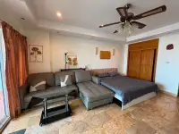 Studio Condo for Sale at View Talay 5D combined living and bedroom space with ceiling fan and marble tile floor