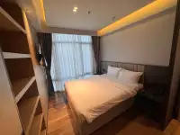 Studio Condo for Sale at View Talay 5D bedroom with king bed, wood flooring, and sheer curtains