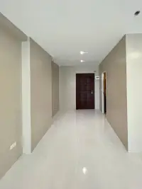 1 Bedroom Condo for Sale at View Talay 6 hallway view with tile flooring leading to dark wood entrance door